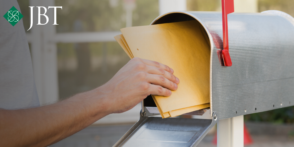 Hand retrieving mail from mailbox