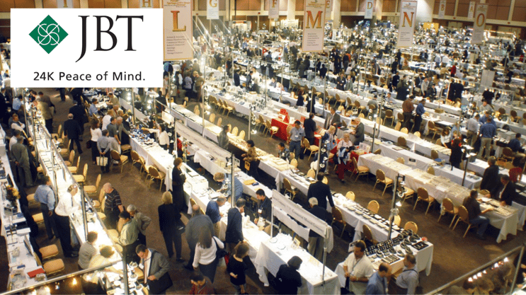 aerial view of jewelry trade show showroom with vendor stands and crowds of people